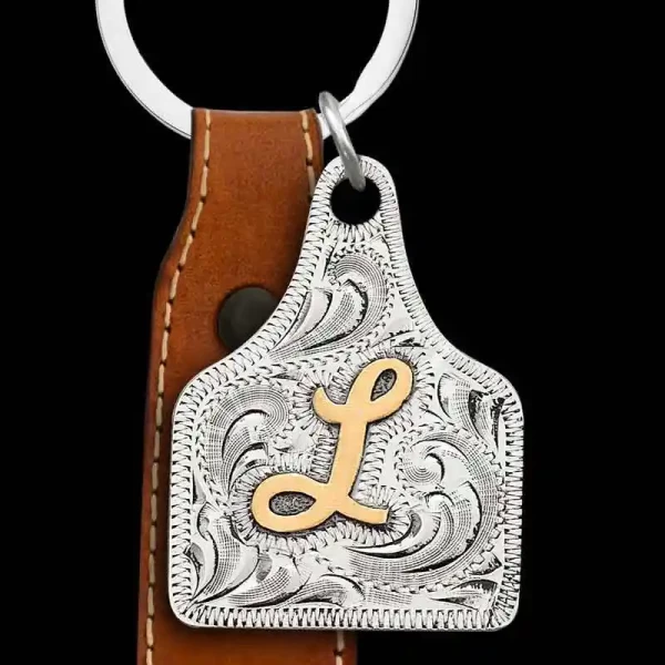 "Our Cattle Town Custom Keychain features an iconic cow tag pendant in the form of a keychain. Crafted on a German Silver base with hand engraving and lettering in Jeweler's Bronze. Customize your keychain with your desired initial, Custom logo, Ranc